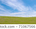 An airplane flying over Biei Hill 71067566