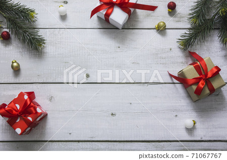 Top view of christmas gift boxes, balls and fir branches on white wooden desk with space for your text Top view of christmas gift boxes, balls and fir branches on white wooden desk with space for your text 71067767