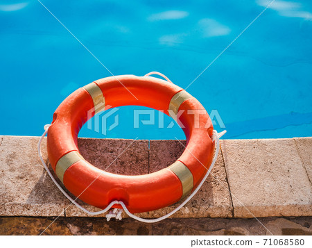 Lifebuoy lying on the background of the pool Lifebuoy lying on the background of the pool 71068580
