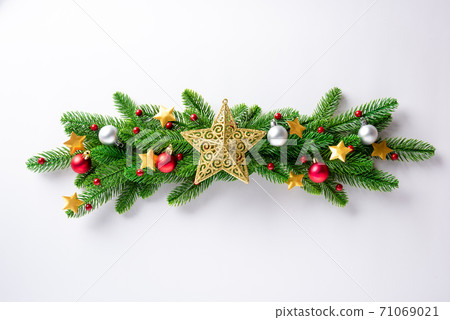 Christmas garland fir tree branches decorated balls and confetti stars Christmas garland fir tree branches decorated balls and confetti stars 71069021