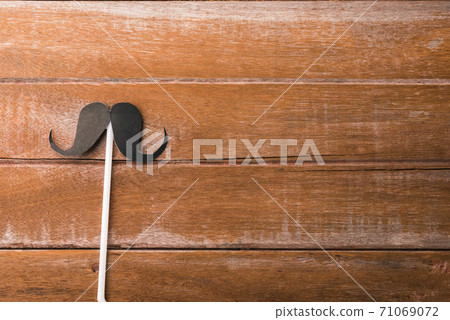 Black mustache paper on wooden 71069072