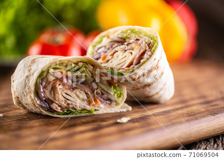 Filled tortilla wrap cut to halves - close-up Filled tortilla wrap cut to halves - close-up 71069504