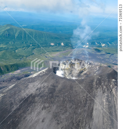 Aerial view to Karymsky volcano, Kamchatka peninsula, Russia Aerial view to Karymsky volcano, Kamchatka peninsula, Russia 71069513