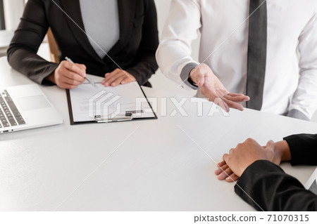 Office executives are interviewing job applicants in the meeting room Office executives are interviewing job applicants in the meeting room 71070315