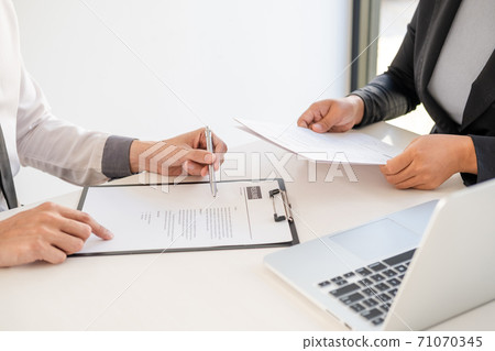 Office executives are interviewing job applicants in the meeting room Office executives are interviewing job applicants in the meeting room 71070345