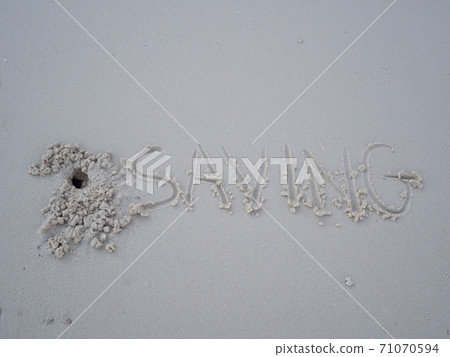 The letters saving were written on the sand with natural beauty The letters saving were written on the sand with natural beauty 71070594