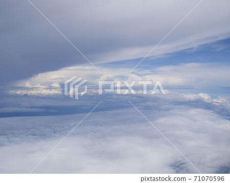 Clouds from airplane window with blue sky 71070596