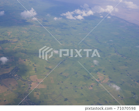 Clouds from airplane window with blue sky and high angle ground Clouds from airplane window with blue sky and high angle ground 71070598