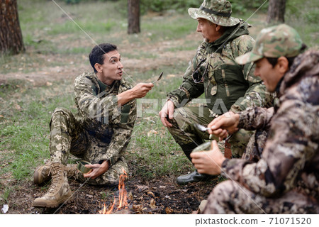 Camp Fire Happy Man Talks to Friends Storytelling. 71071520
