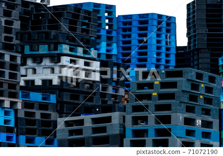 Selective focus on plastic shipping pallet stack. Industrial plastic pallet stacked at factory. Cargo and shipping. Plastic pallet rack for export delivery industry. Plastic pallet storage warehouse. 71072190