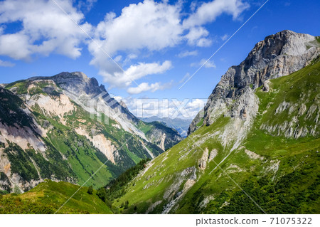 Mountain and pastures landscape in French alps Mountain and pastures landscape in French alps 71075322