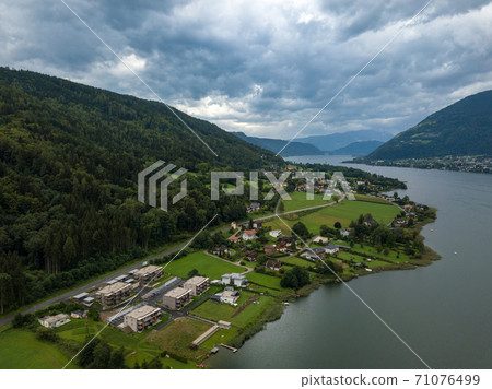 Aerial view on Ossiacher Lake in Carinthia, Austria from Old Ossiach on a cloudy summer day. 71076499