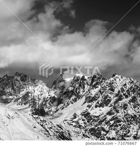 Black and white snowy rocks in clouds Black and white snowy rocks in clouds 71076667