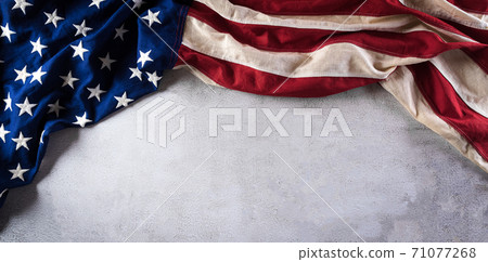 Happy Veterans Day concept. American flags against gray stone background. November 11. Happy Veterans Day concept. American flags against gray stone background. November 11. 71077268