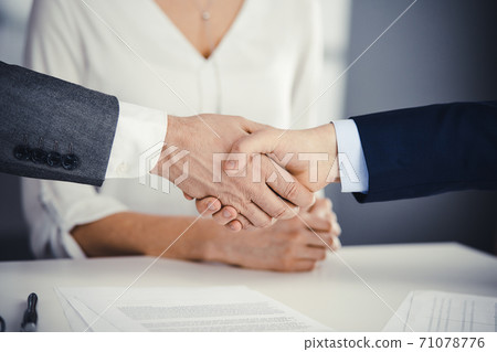 Business people shaking hands finishing contract signing, close-up. Business communication concept. Handshake and marketing Business people shaking hands finishing contract signing, close-up. Business communication concept. Handshake and marketing 71078776