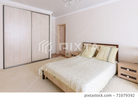 Interior of a spacious, light, cozy bedroom Interior of a spacious, light, cozy bedroom 71079392