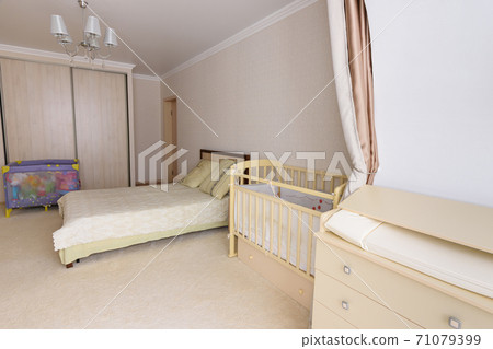 Sleeping room converted for a newborn baby, there is a changing table, a cot and a playpen Sleeping room converted for a newborn baby, there is a changing table, a cot and a playpen 71079399