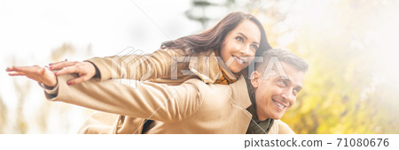 A couple in love enjoying sunny but chilly autumn day outdoors A couple in love enjoying sunny but chilly autumn day outdoors 71080676