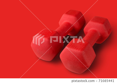 pair of big red dumbbells on red background, concept pair of big red dumbbells on red background, concept 71085441