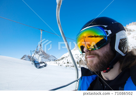 Man skier sitting in ski lift 71086502