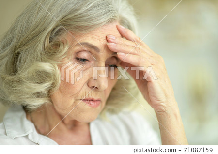 Close-up portrait of beautiful sad senior woman Close-up portrait of beautiful sad senior woman 71087159