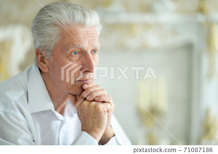 Close-up portrait of sad thinking senior man 71087186