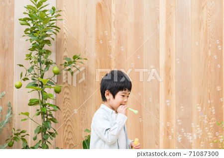 Boys playing with soap bubbles 71087300
