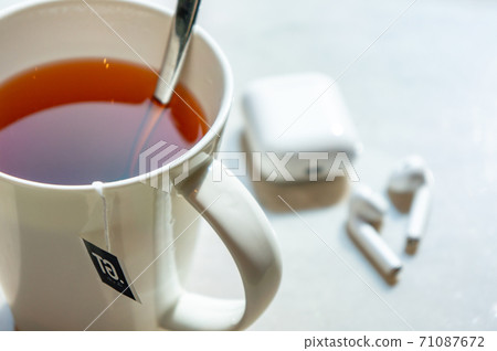 Tea and earphones Tea and earphones 71087672