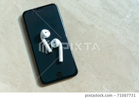 White wireless earphones and smartphone White wireless earphones and smartphone 71087731