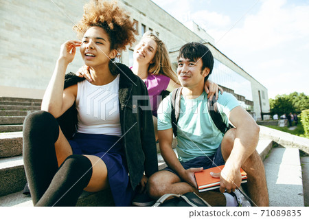 cute group of teenages at the building of university with books huggings, diversity nations, having lunch cute group of teenages at the building of university with books huggings, diversity nations, having lunch 71089835