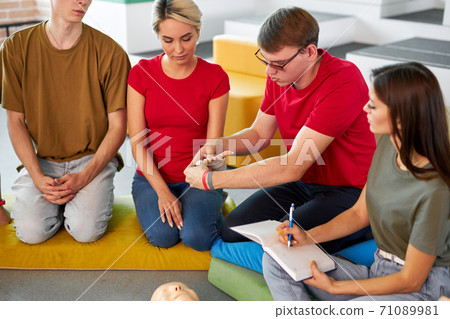 group of people practice treating a patient by bandages 71089981
