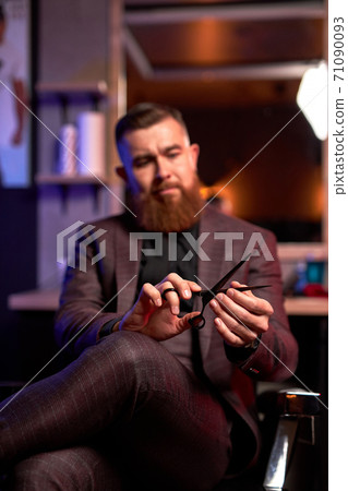 close-up photo of shears in hands of professional male barber 71090093