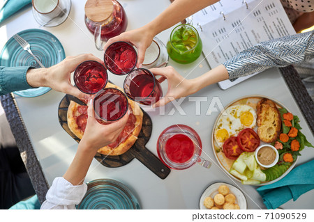 top view on people hands clinking glasses with beverages top view on people hands clinking glasses with beverages 71090529