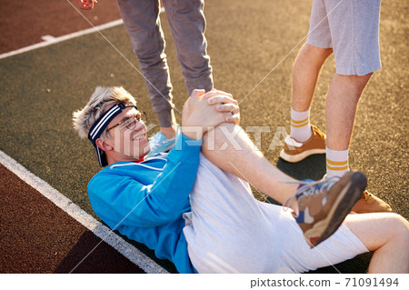 basketball player fell to his knee on the court basketball player fell to his knee on the court 71091494