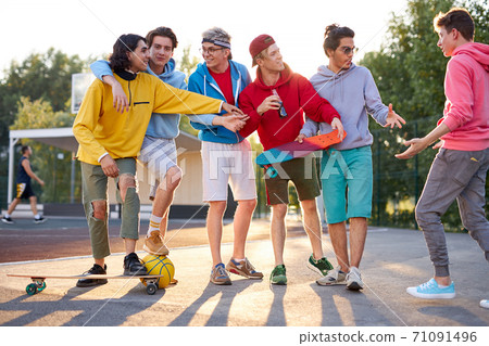 city teenagers have fun outdoors at sport playground, in the park 71091496