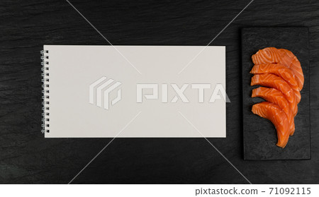 Slices of Raw Salmon Fillet on Black Background Mockup Top View Slices of Raw Salmon Fillet on Black Background Mockup Top View 71092115