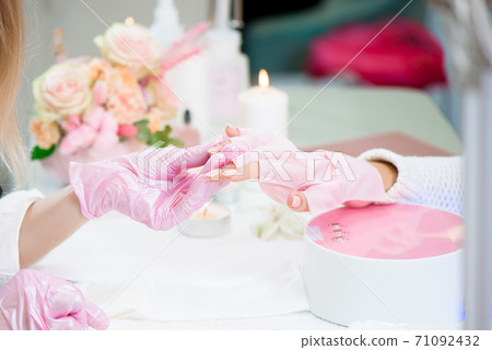 Women doing manicure. Small business existence at COVID-19 lockdown concept. Women doing manicure. Small business existence at COVID-19 lockdown concept. 71092432