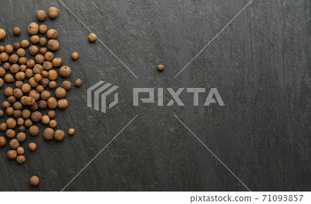 Pile of allspice on black stone background. Jamaica pepper Pile of allspice on black stone background. Jamaica pepper 71093857