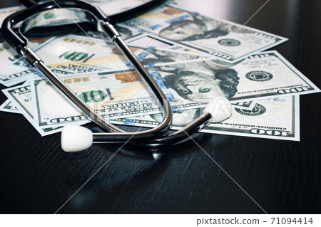 Stethoscope on hundred dollar bills close up 71094414