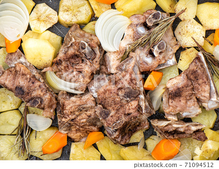 Stewed pork bones with potatoes, onions, carrots, rosemary. Stewed pork bones with potatoes, onions, carrots, rosemary. 71094512