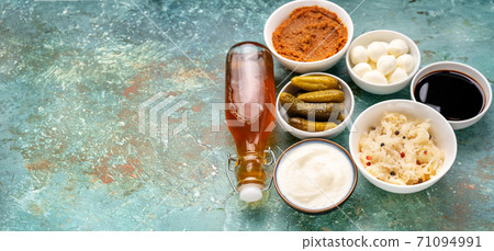 Many fermented products on light turquoise background Many fermented products on light turquoise background 71094991
