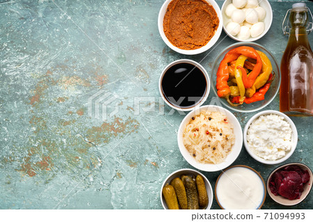 Variety of healthy fermented foods on light mint background Variety of healthy fermented foods on light mint background 71094993