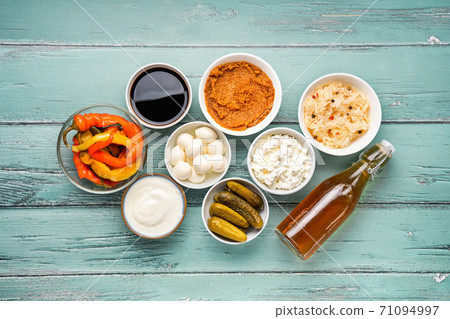 Variety of fermented foods on light mint background Variety of fermented foods on light mint background 71094997