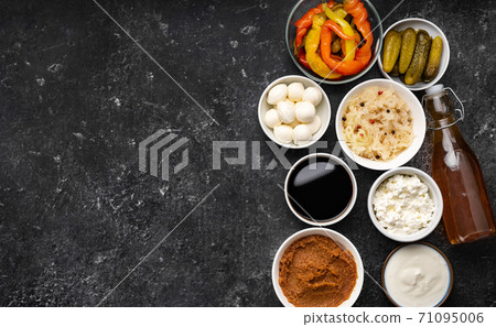 Close up of many fermented foods on black background Close up of many fermented foods on black background 71095006