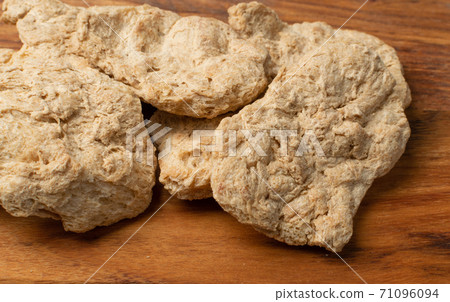 Raw Dehydrated Soy Meat or Soya Chunks on Wood Background Raw Dehydrated Soy Meat or Soya Chunks on Wood Background 71096094