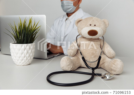 Stuffed Teddy Bear with stethoscope in pediatrician office. Child healtcare concept 71096153