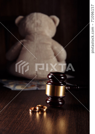 Alimony payment. Dollar banknotes, judge gavel with rings and teddy bear. Family divorce and alimony concept 71096157