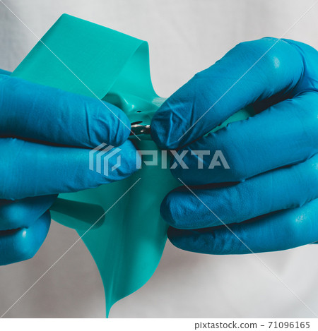 Dental procedure, installation of a cofferdam to the patient, modern treatment, preparation for installation. Dental procedure, installation of a cofferdam to the patient, modern treatment, preparation for installation. 71096165