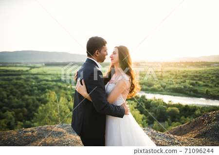 Gorgeous happy couple standing close to each other and looking in eyes 71096244