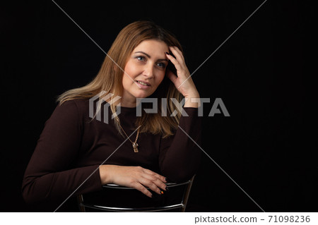 Portrait of a forty-year-old beautiful European woman on a black background 71098236